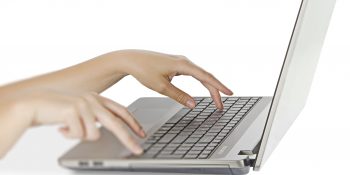 Woman typing on notebook